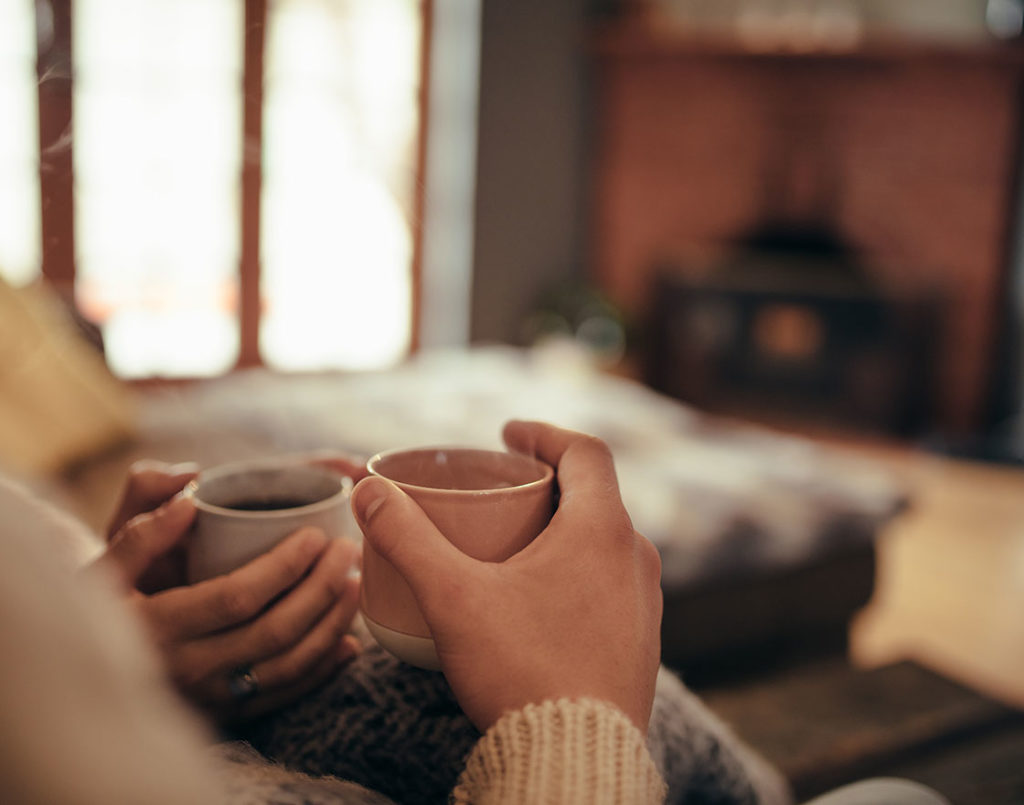 warm and cozy home with 2 people drinking coffee