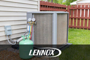 A central air conditioning unit in a residential backyard that is get recharged during a spring maintenance visit in Springfield, IL.