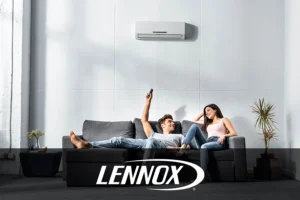 A young couple sits on the couch and enjoys a functioning indoor air conditioner to keep their home cool and comfortable in Springfield, IL.