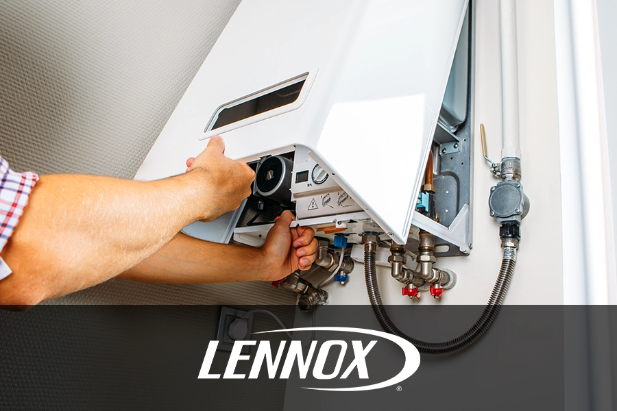 The arms of an expert plumber performing maintenance services on a boiler in a Springfield, IL home.