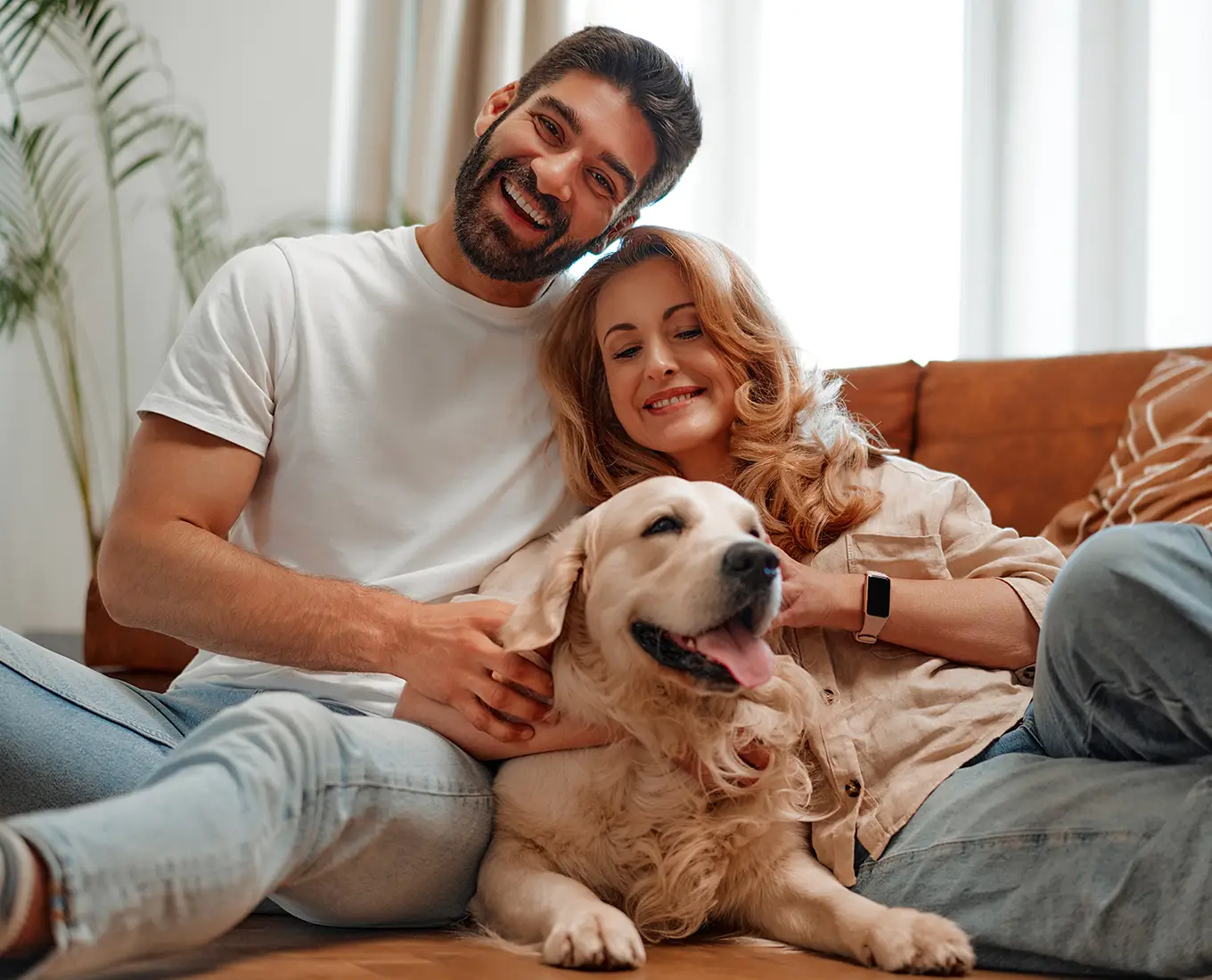 Happy couple relaxing with their dog in a comfortable home supported by reliable HVAC services from Bormida Heating & Cooling in Springfield, IL.
