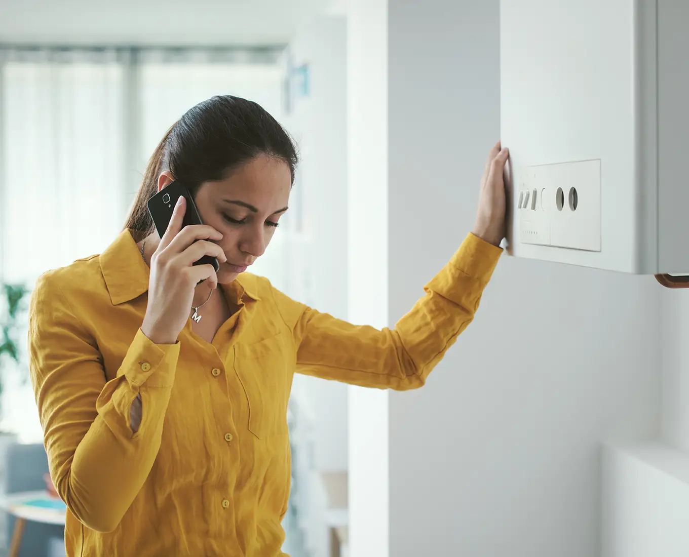 Homeowner calling for help when her HVAC system stops working, relying on 24/7 HVAC service in Springfield, IL.