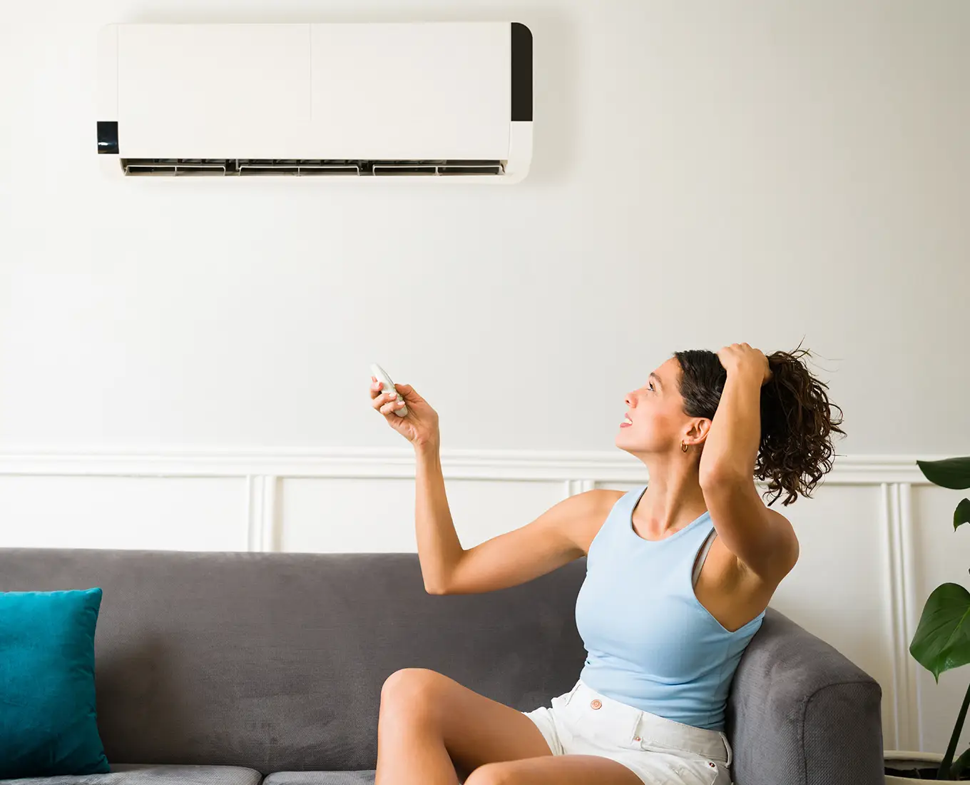 Homeowner adjusting a ductless mini split air conditioner system supported by 24/7 HVAC service in Springfield, IL.