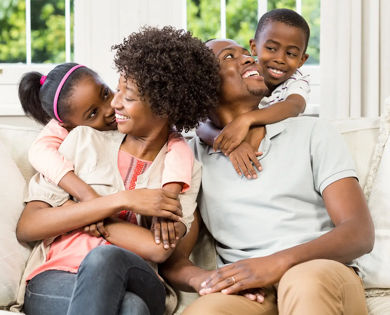Family relaxing together on the couch in a comfortable home supported by reliable air conditioning and cooling services in Springfield, IL.