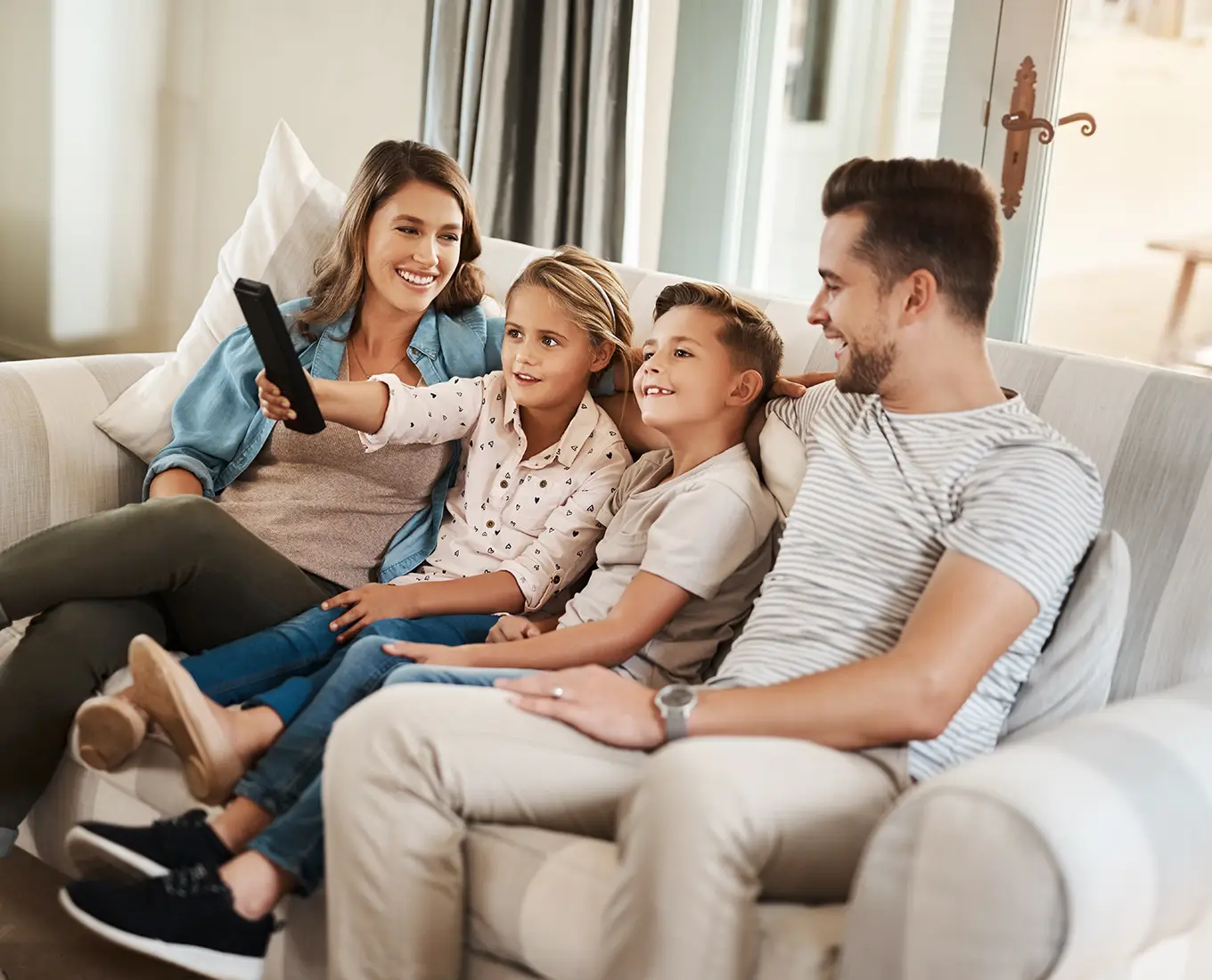 Family relaxing together indoors enjoying cool air from professional air conditioning services in Springfield, IL.