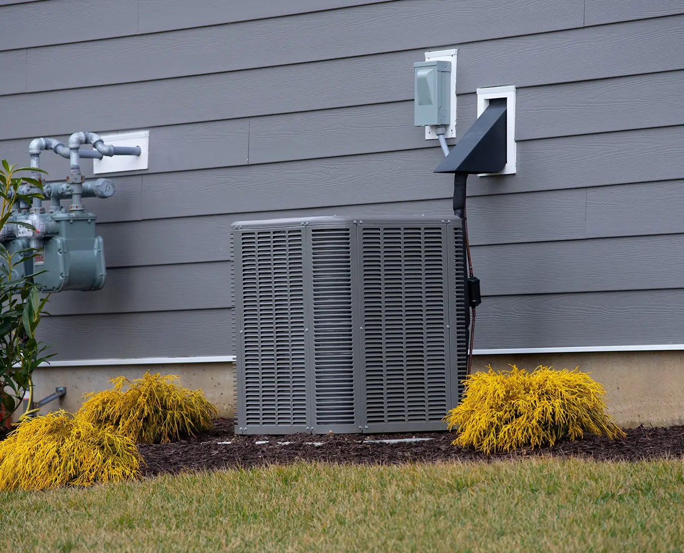 Residential central air conditioning unit installed beside a home providing reliable cooling after AC replacement in Springfield, IL.