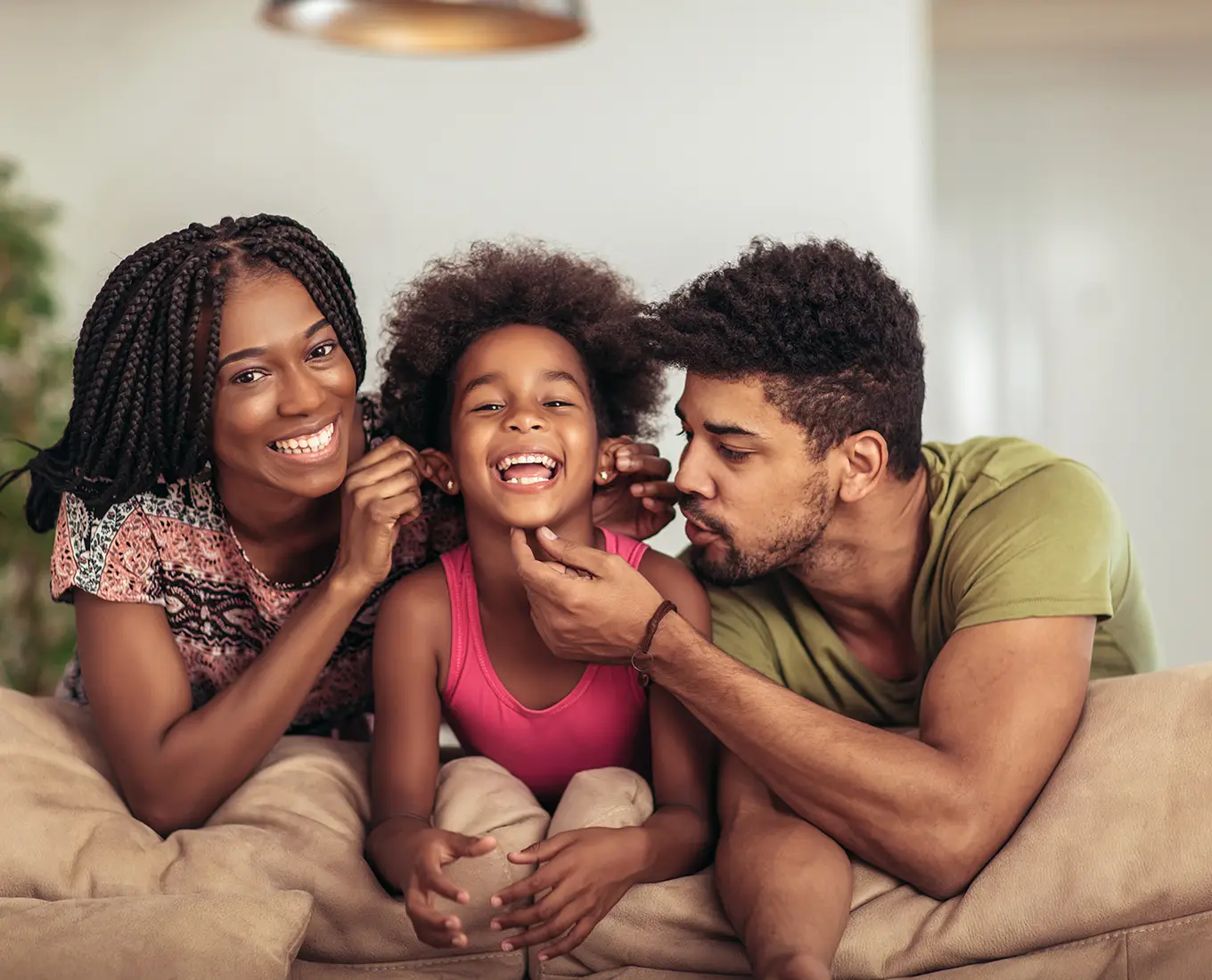 Happy family relaxing comfortably at home thanks to reliable AC maintenance and air conditioning service in Springfield, IL.