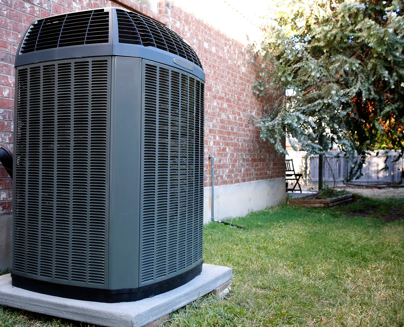 Residential outdoor heat pump system installed beside a home for efficient heating and cooling in Springfield, IL.