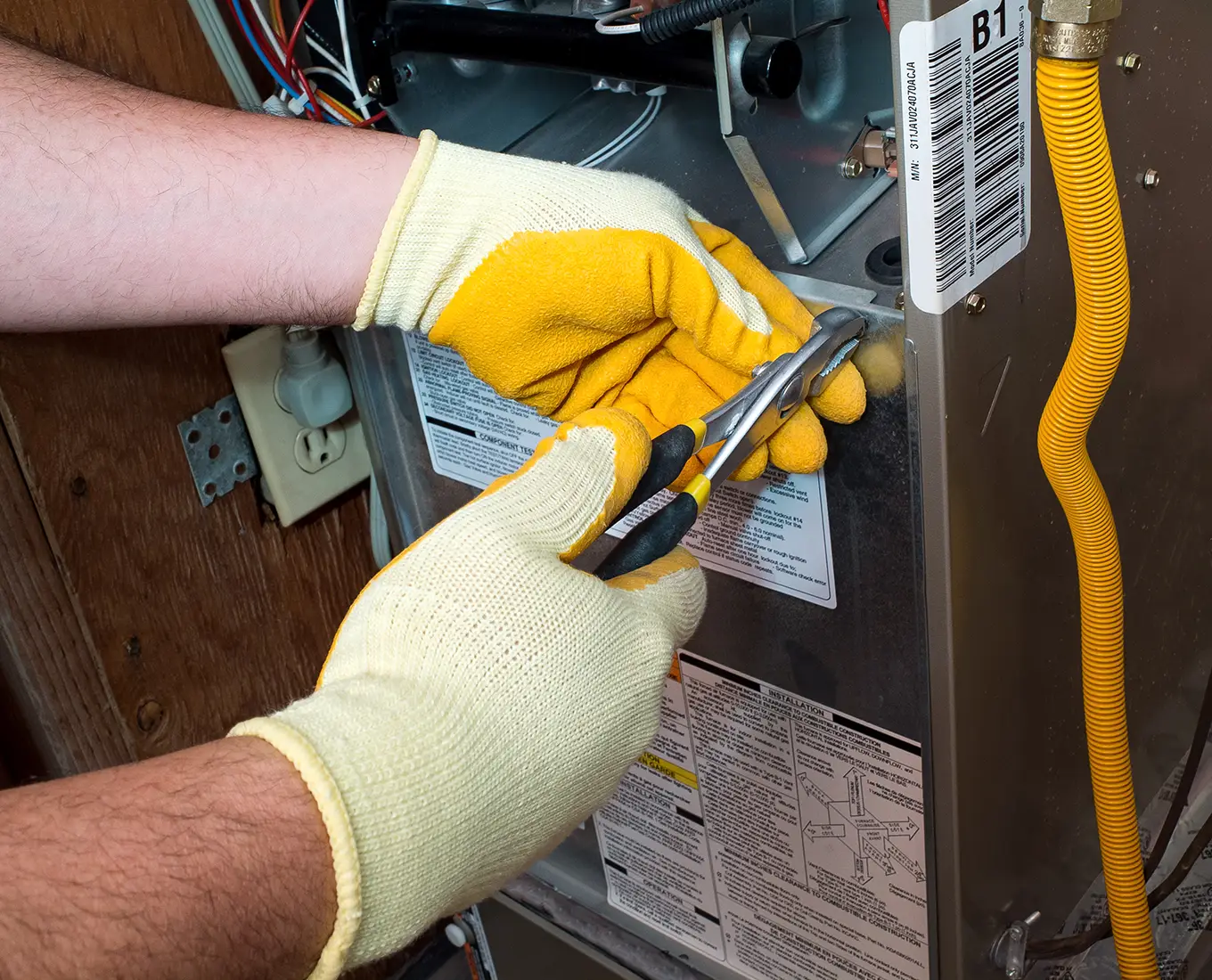 HVAC technician repairing furnace components as part of furnace repair service in Springfield, IL by Bormida Heating & Cooling.