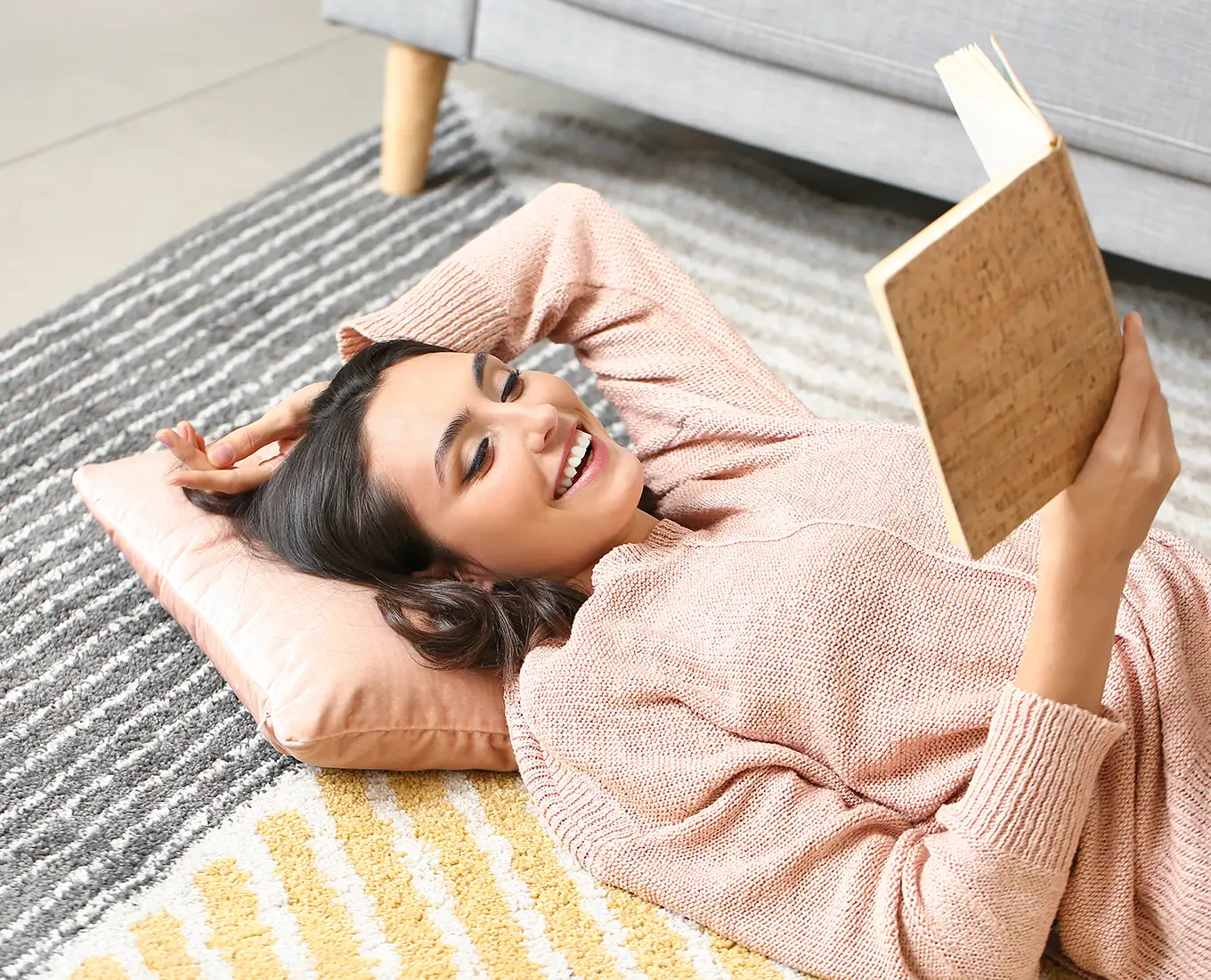 Woman relaxing and reading comfortably indoors showcasing effective heating and cooling services in Springfield, IL