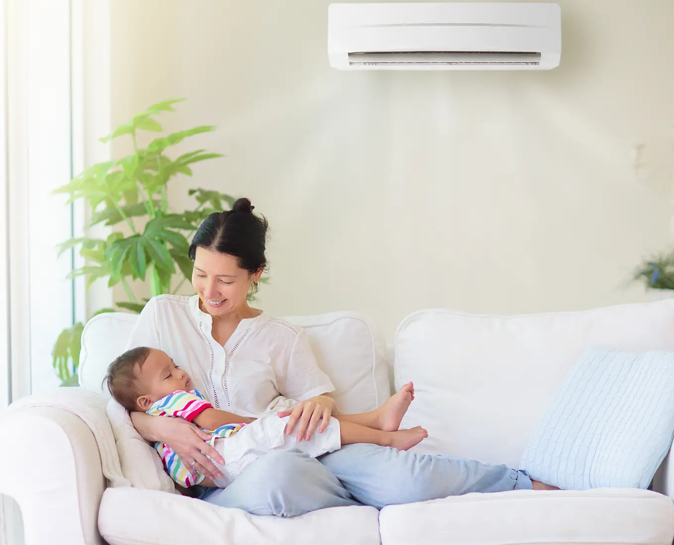 Mother and baby relaxing comfortably indoors with efficient cooling after emergency AC repair in Springfield, IL