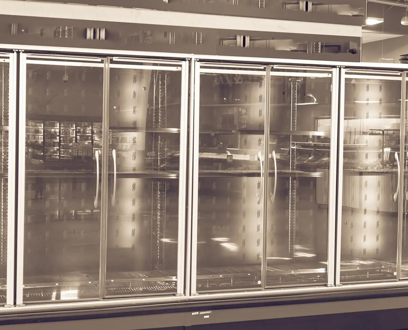 Large commercial glass door freezer cases used in retail environments and maintained through commercial refrigeration services in Springfield, IL.