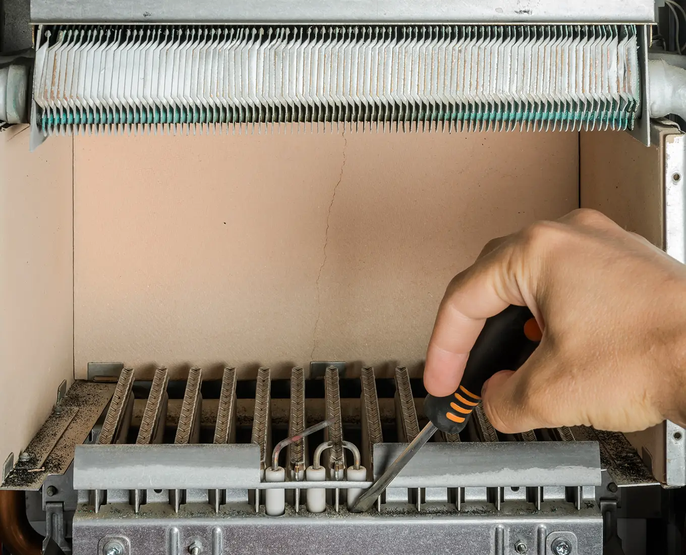 Technician inspecting furnace burner components during residential and commercial furnace repair in Springfield, IL