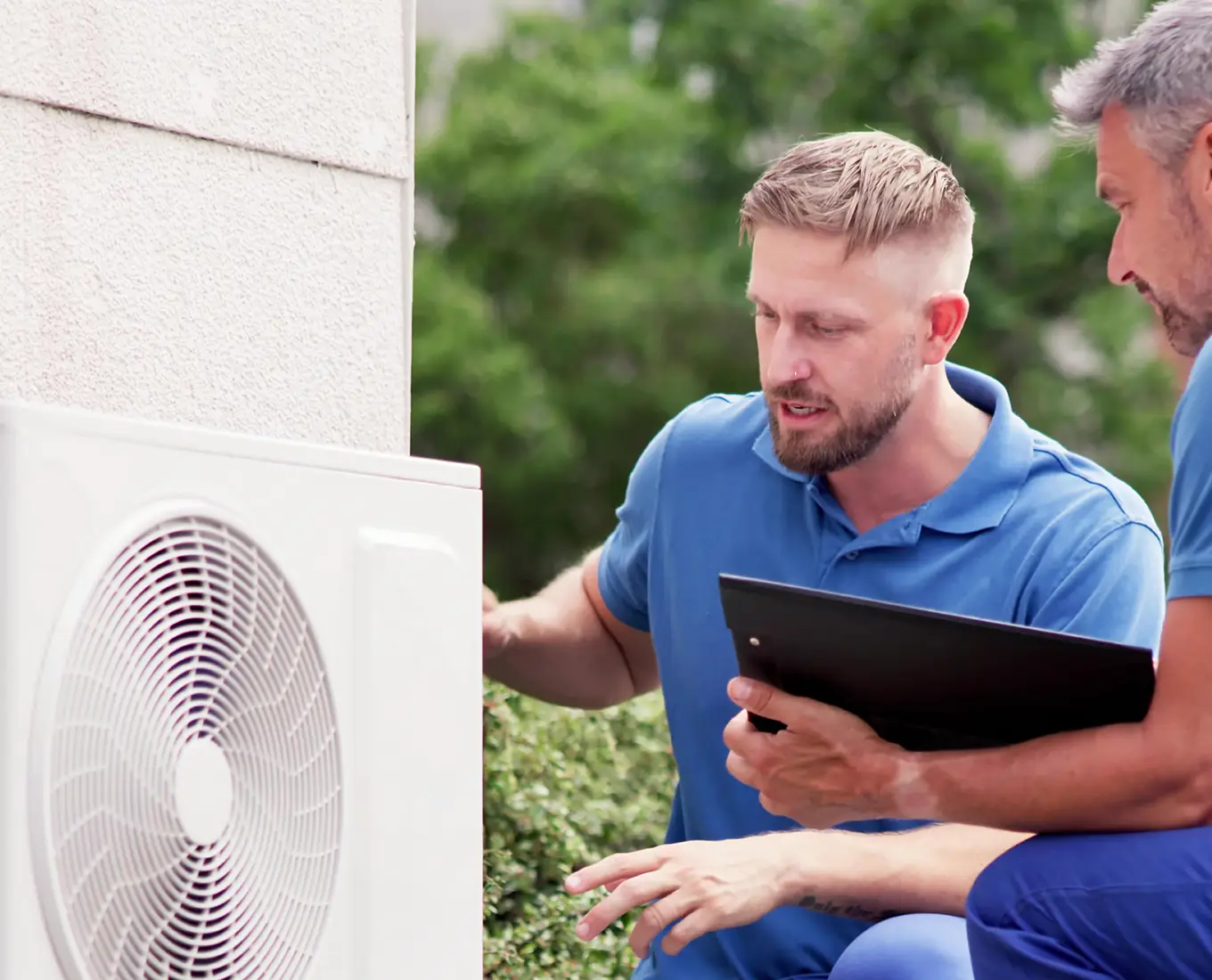 HVAC technicians inspecting and servicing ductless mini split outdoor unit for efficient heating and cooling in Springfield IL