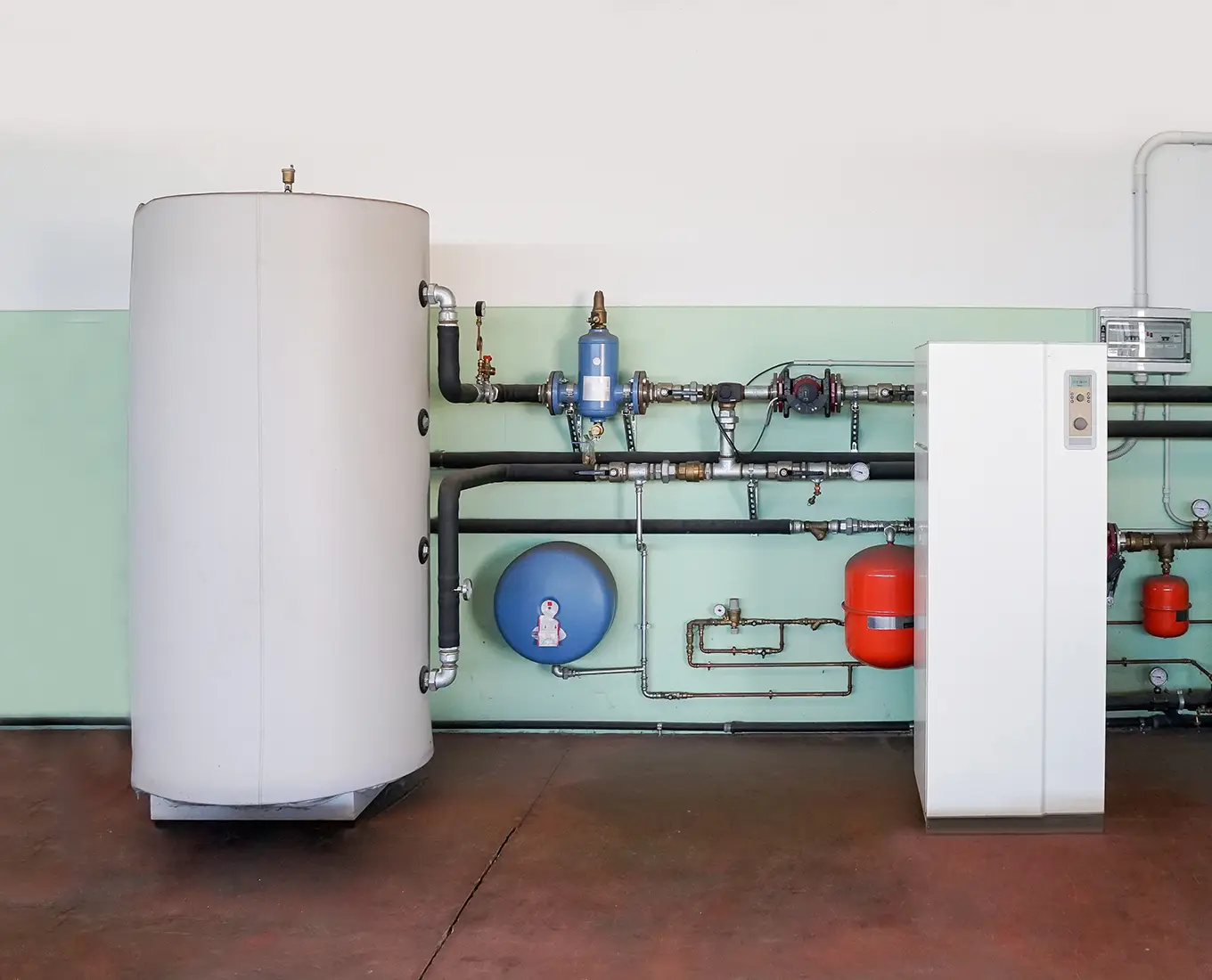 Indoor geothermal heat pump and tank system used for energy-efficient heating and cooling with geothermal HVAC service in Springfield, IL.